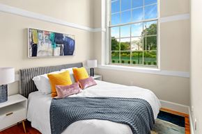Beverly apartment for rent - a bedroom with a bed and a large window at Beverly Village for Living & the Arts Apartments, Beverly, 01915