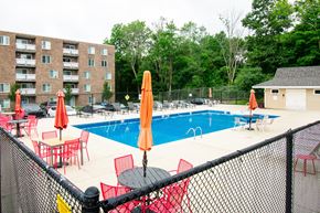 Stoughton apartment for rent - our apartments have a large pool and a patio with chairs at North Stoughton Village, Massachusetts