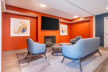 A living room with couches and chairs and a fireplace