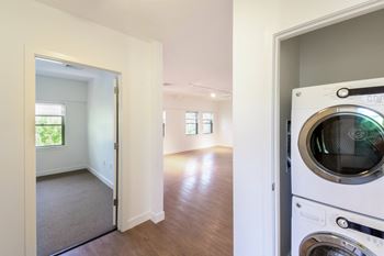 A laundry room with a washer and a dryer in a house