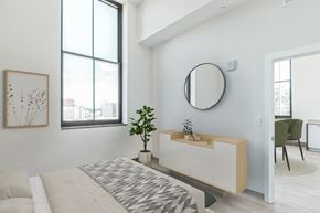 Pittsburgh apartment for rent - a bedroom with a bed and a mirror on the wall at Letsche School, Pennsylvania