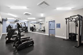 Pittsburgh apartment for rent - A gym with a variety of equipment including treadmills, weights, and exercise machines.