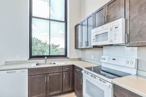 Pittsburgh apartment for rent - an empty kitchen with white appliances and a window at Letsche School, Pittsburgh, PA