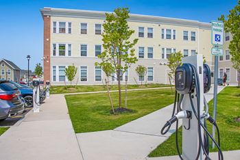 A row of electric cars parked in front of a building