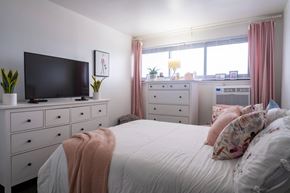 Yonkers apartment for rent - a bedroom with a large bed in front of a window at Dorado Apartments, New York