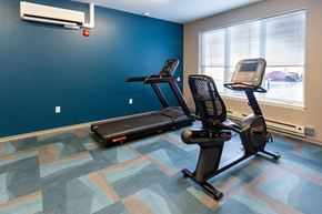 Menands apartment for rent - A gym with a treadmill and a stationary bike. at 35 Broadway Apartments, Menands, New York