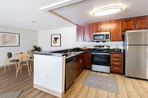 Littleton apartment for rent - A kitchen with wooden cabinets and stainless steel appliancesA kitchen with wooden cabinets and stainless steel appliances at Pondside at Littleton Apartments in Littleton, MA, 01460