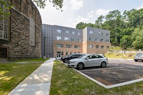 Pittsburgh apartment for rent - a large brick building with a parking lot in front of it at The Carina, Pittsburgh, PA