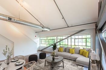 A living room with a gray couch and a coffee table