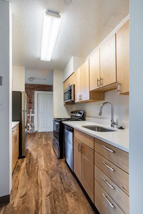 New Haven apartment for rent - A kitchen with wooden floors and white walls at Brewery Square Apartments, Connecticut, 06513