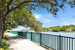 New Haven apartment for rent - A green fence runs along a walkway next to river walk at water at Brewery Square Apartments, New Haven , CT