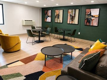Pittsburgh apartment for rent - A living room with a brown couch and a round table.