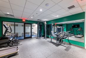 Boston apartment for rent - a gym with exercise equipment and mirrors in a building with green walls  at 140 Clarendon, Massachusetts, 02116