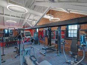 New Haven apartment for rent - a gym with weights and cardio equipment and a brick wall at Ninth Square Apartments, Connecticut, 06510