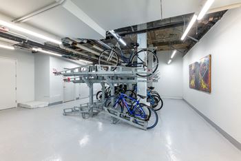 A group of bikes on a rack in a room