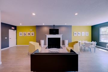 Brockton apartment for rent - a living room with yellow walls and a fireplace and a table and chairs