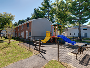 Springfield apartment for rent - A playground with a yellow slide and a blue slide.