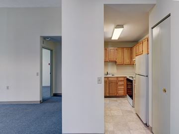 Malden apartment for rent - A kitchen with wooden cabinets and a refrigerator.