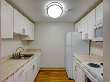 West Roxbury apartment for rent - A kitchen with white cabinets and appliances.