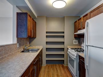 Lynn apartment for rent - a kitchen with a stove and a sink and a refrigerator