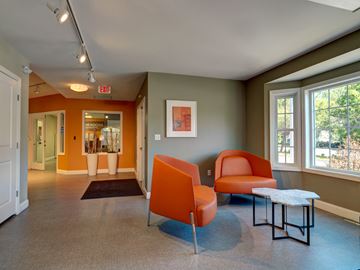 Mansfield apartment for rent - a living room with orange chairs and a table