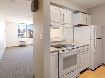Boston apartment for rent - an empty kitchen with white appliances and white cabinets
