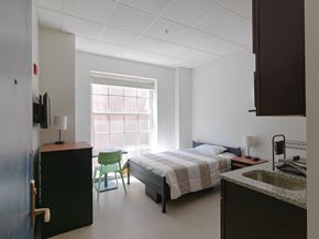 Boston apartment for rent - a bedroom with a bed and a sink and a chair  at 140 Clarendon, Boston, MA, 02116