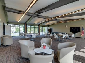 New Hartford apartment for rent - Resident Community Room with Seating, TV, Library and Large Windows at Meadows Senior Living Apartments, New Hartford