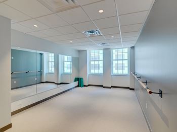 An empty room with a large window and glass doors