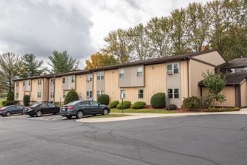 Latrobe apartment for rent - A parking lot in front of a building with cars parked.