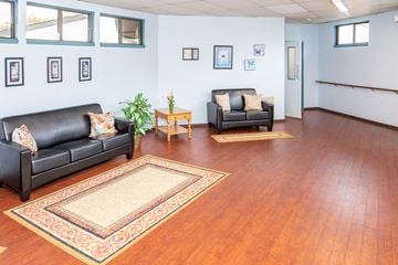 Latrobe apartment for rent - A living room with a black couch and a rug.