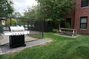 Grilling station with benches and landscaped grounds