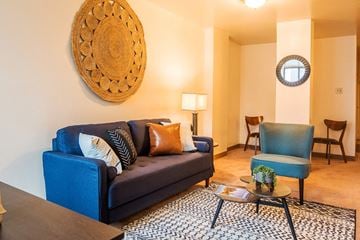 Pittsburgh apartment for rent - A living room with a blue couch and a wooden coffee table.