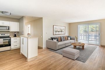 Hudson apartment for rent - a living room and kitchen with a couch and a table