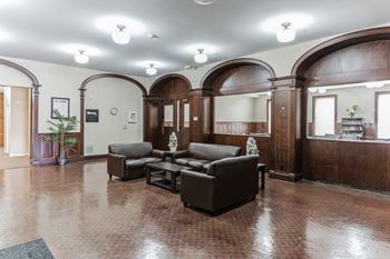 A resident clubhouse with leather couches and a coffee table
