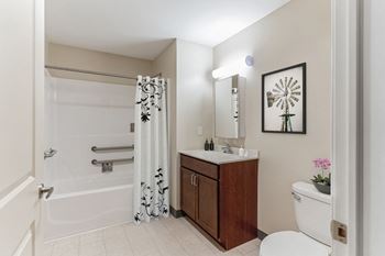 A bathroom with a toilet sink and bathtub