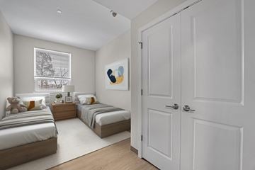 Pittsburgh apartment for rent - A white bedroom with two beds and a white door.