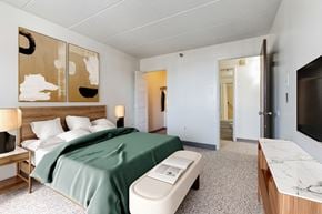 Wheeling apartment for rent - a bedroom with a bed and a desk in a room at Montani Towers, Wheeling