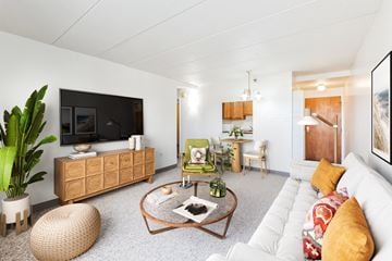 Wheeling apartment for rent - A living room with a white couch and a wooden coffee table.