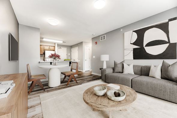 Buffalo apartment for rent - Living And Dining Area With Gray Couch And Ottoman at Niagara Square, Buffalo, 14201