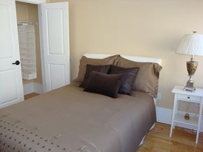 Lawrence apartment for rent - Bedroom with brown bedsread at Sacred Heart Apartments, Massachusetts, 01843