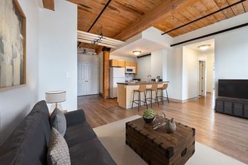 Haverhill apartment for rent - A living room with a grey couch and a wooden coffee table.