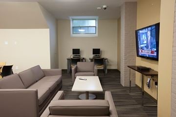 Lawrence apartment for rent - a living room with couches and chairs and a television