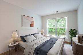 Abington apartment for rent - a bedroom with a bed and a large window at Woodlands at Abington Station, Abington, MA