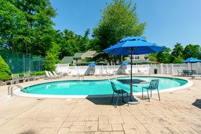 Marshfield apartment for rent - A blue umbrella is next to a pool table at at Mariner's Hill Apartments, Massachusetts.