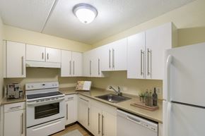 Stoughton apartment for rent - the preserve at ballantyne commons apartment kitchen with white cabinets and appliances at North Stoughton Village, Massachusetts, 02072