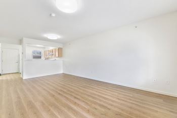 A room with wooden flooring and white walls