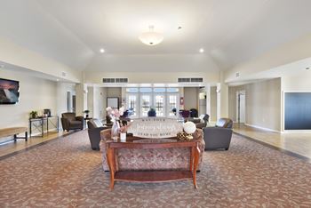 A living room with a couch and a coffee table in the middle