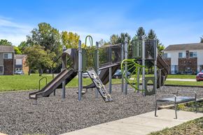 Columbus apartment for rent - A playground with a green slide and a brown slide.