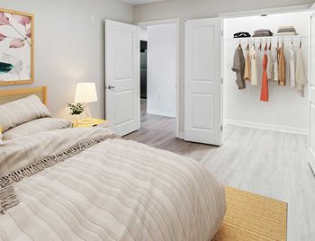 A bedroom with a bed and a closet